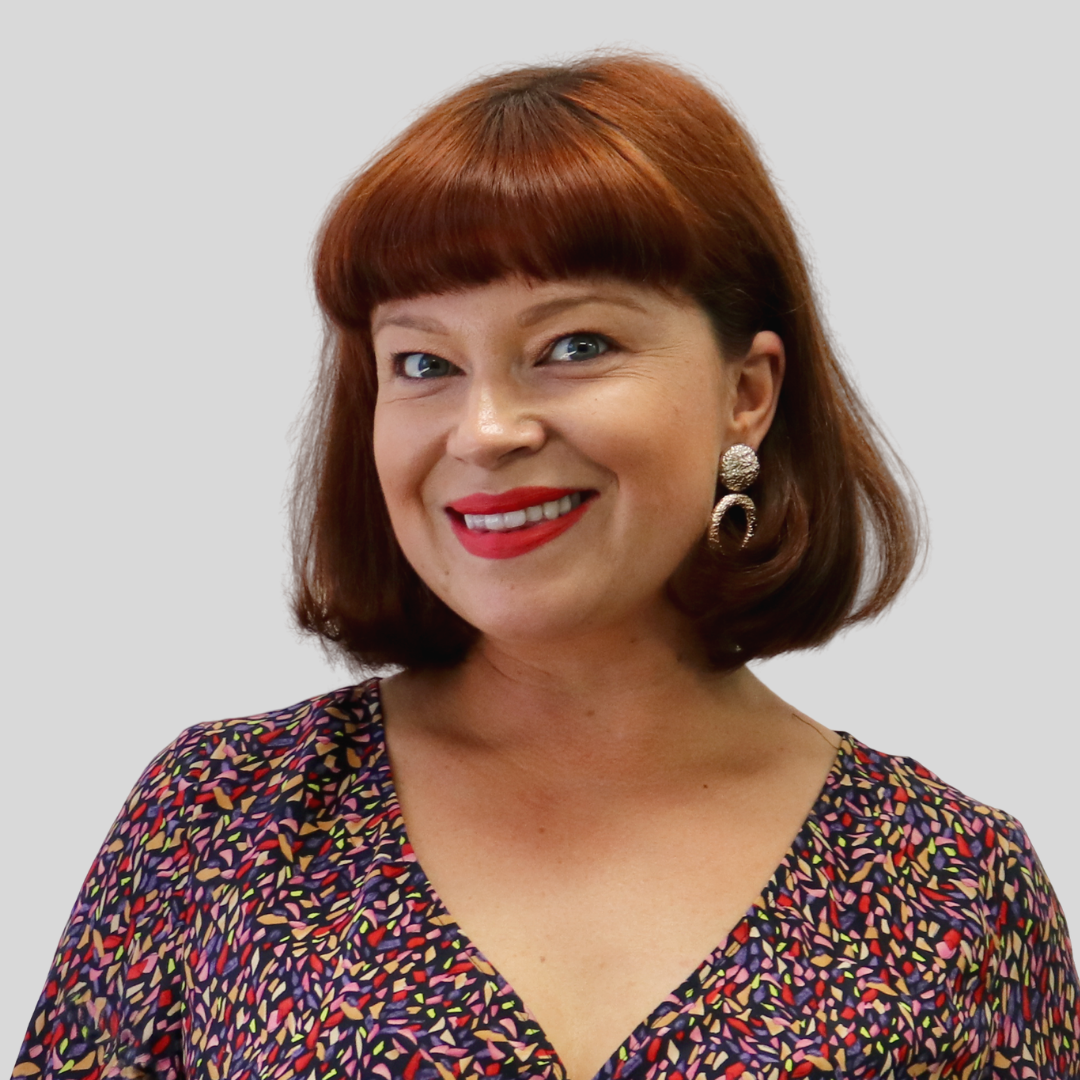 Sarah Ricardo wearing a colourful speckled shirt with complimentary red lipstick