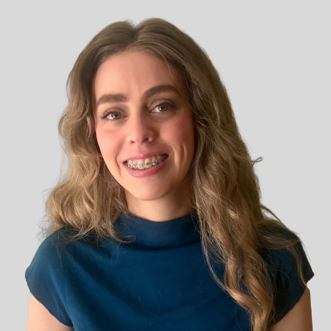 Honor Cass wearing a dark blue top with a high neckline