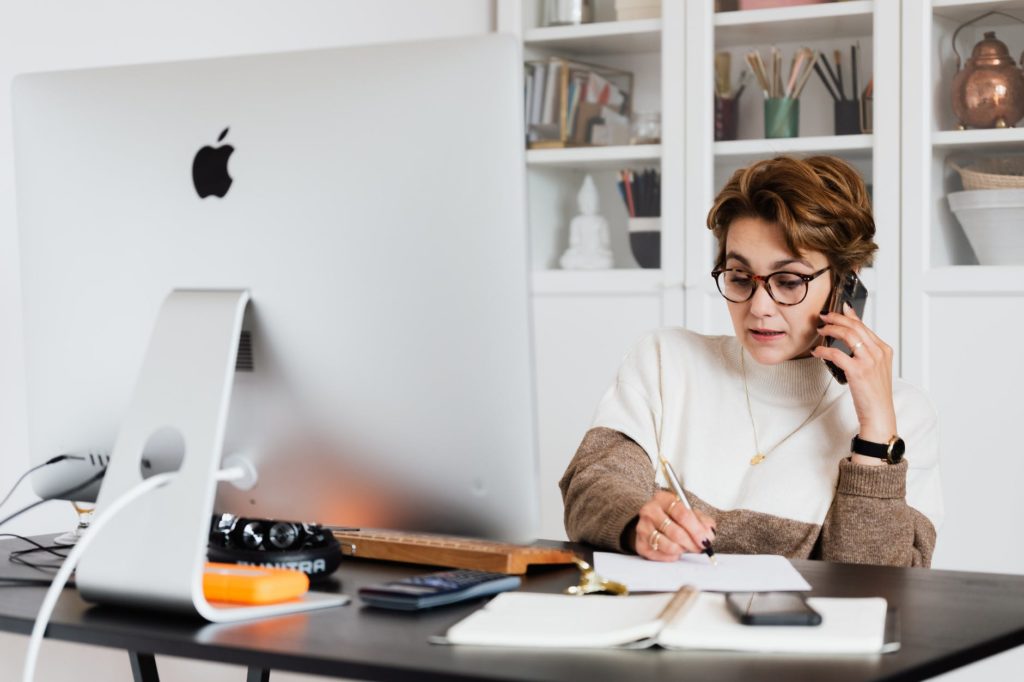 Woman on the phone in front of a computer