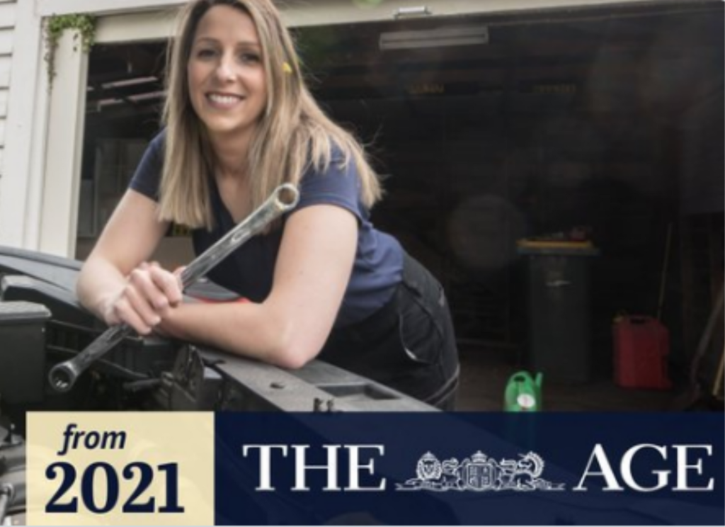 The Age Article, a woman smiles as she leans over a car holding a wrench