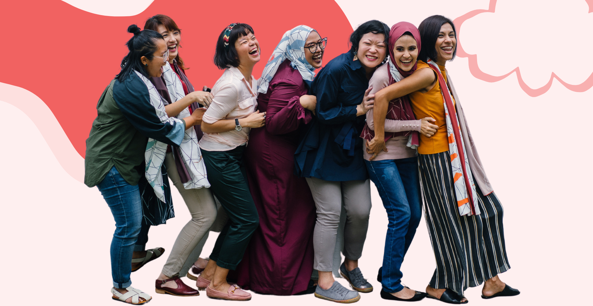7 diverse women stand in a line laughing with their arms around one another.