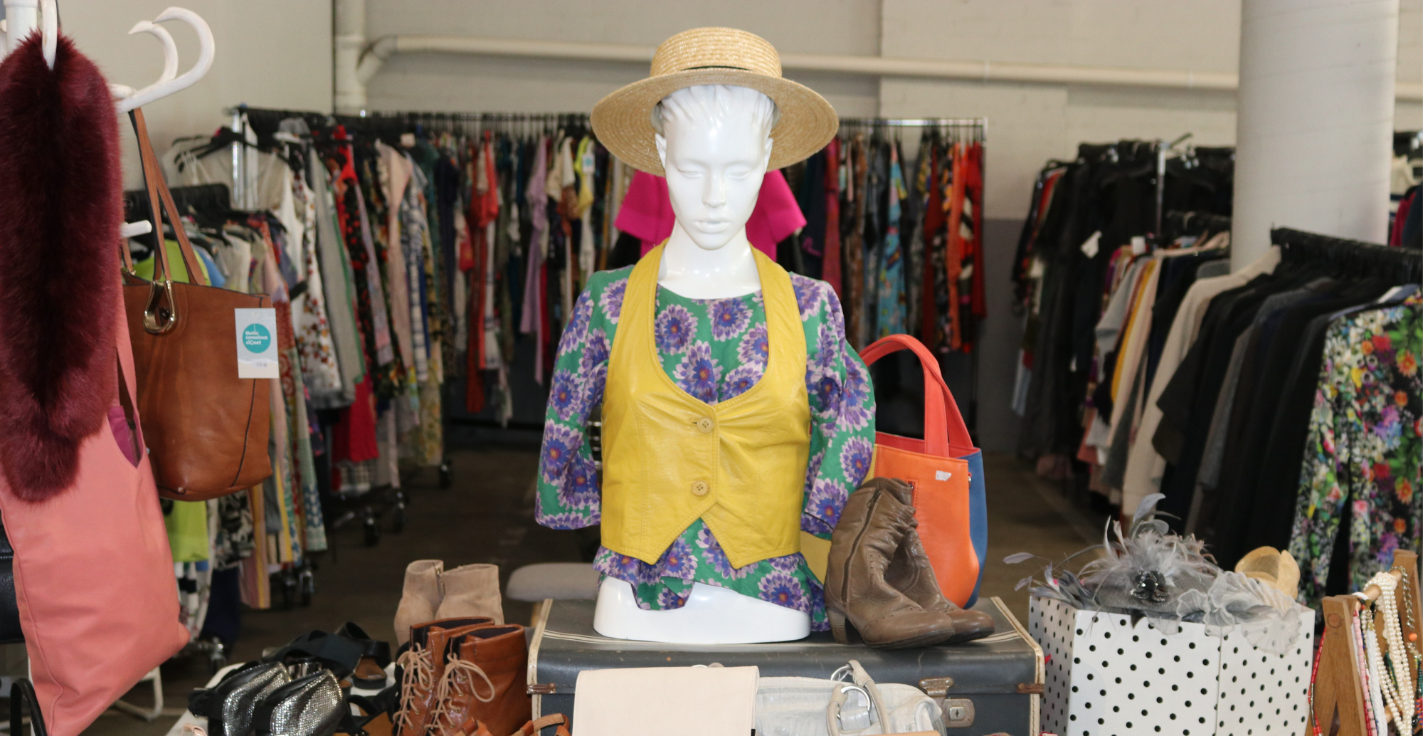 stylish mannequin on a table with accessories and beautiful clothing in the background
