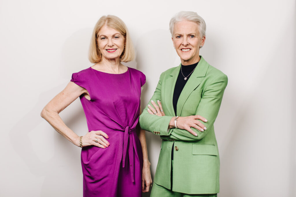 Fitted for Work's incoming Chair (Launa Inman) and outgoing Chair (Wendy Stop) pose together, smiling.